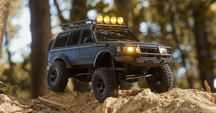 RC truck with LED lights on rocky terrain