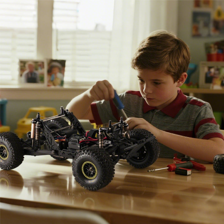 Boy assembling a remote-controlled toy vehicle.