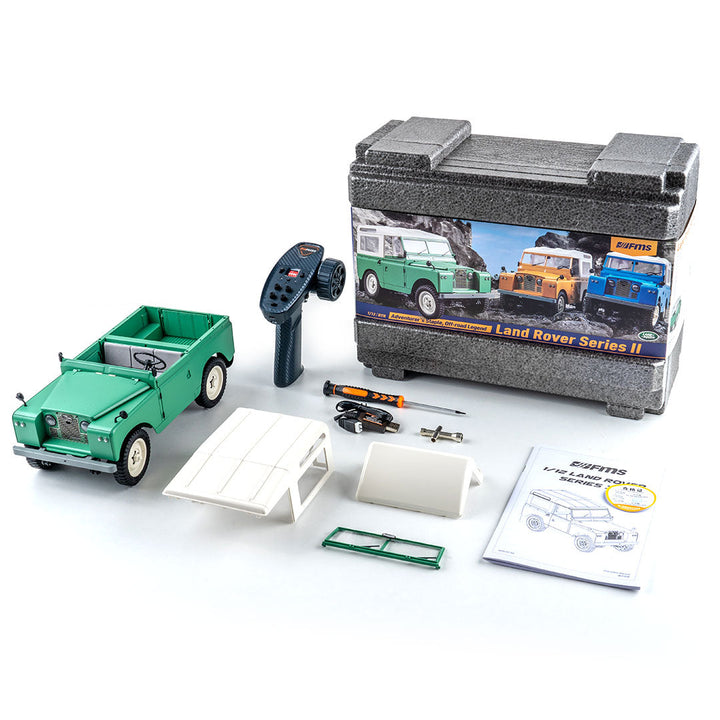 This complete Fmshobby RC Trucks set includes a scale Land Rover, remote, and essential maintenance tools