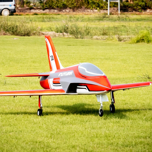 Front view of the FMS Futura V3 jet resting on a green grass field with its landing gear deployed