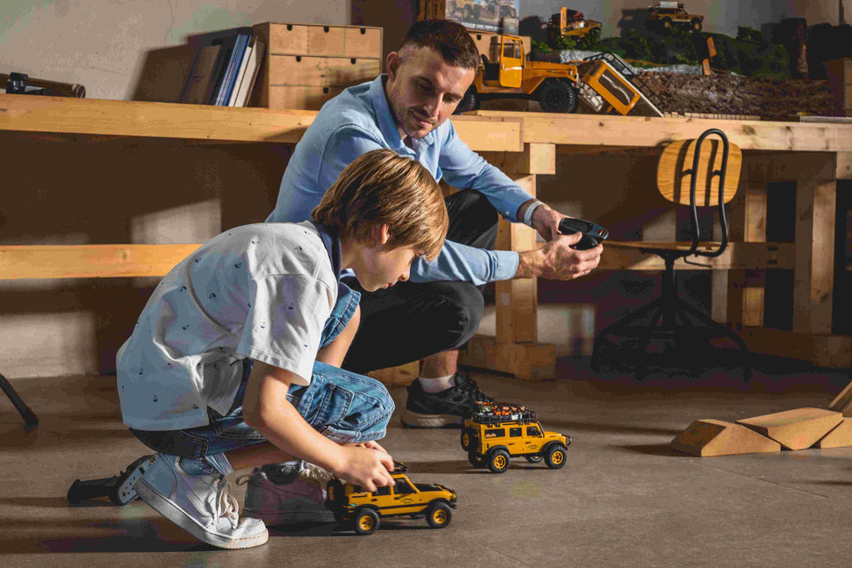Father and son playing with RC cars.
