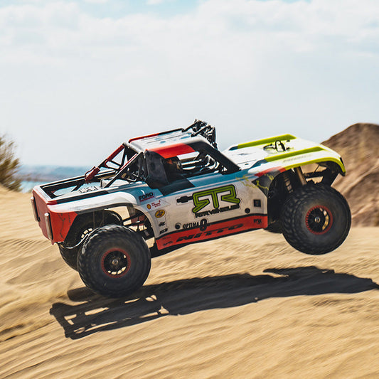 Colorful off-road race truck speeding through desert terrain