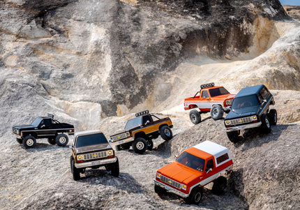 FMS RC Cars navigating a steep rocky landscape, blending vintage aesthetics with powerful off-road performance