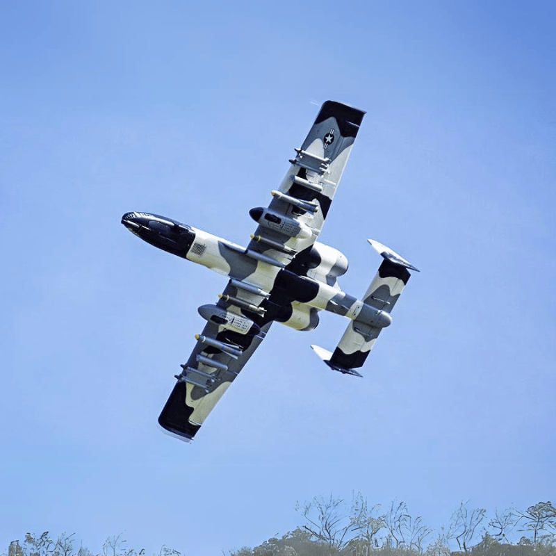 FMS A-10 Thunderbolt II V2 jet performing aerial maneuvers with camouflage design.
