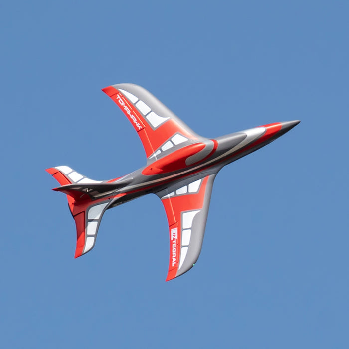 FMS EDF Jet 80mm Integral soaring through the sky in red and gray design.