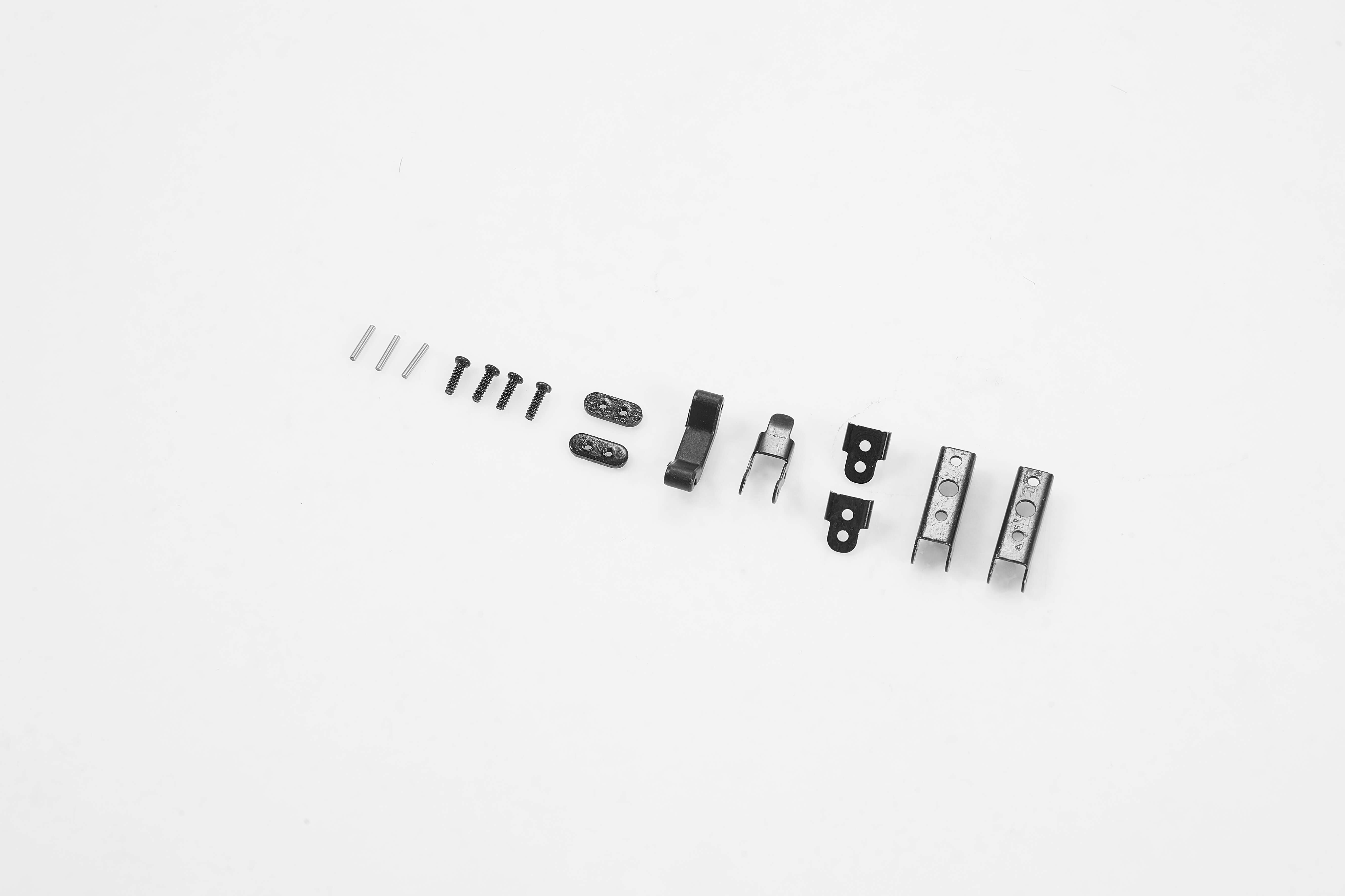Black hardware parts for RC vehicles including screws, clips, and locks.