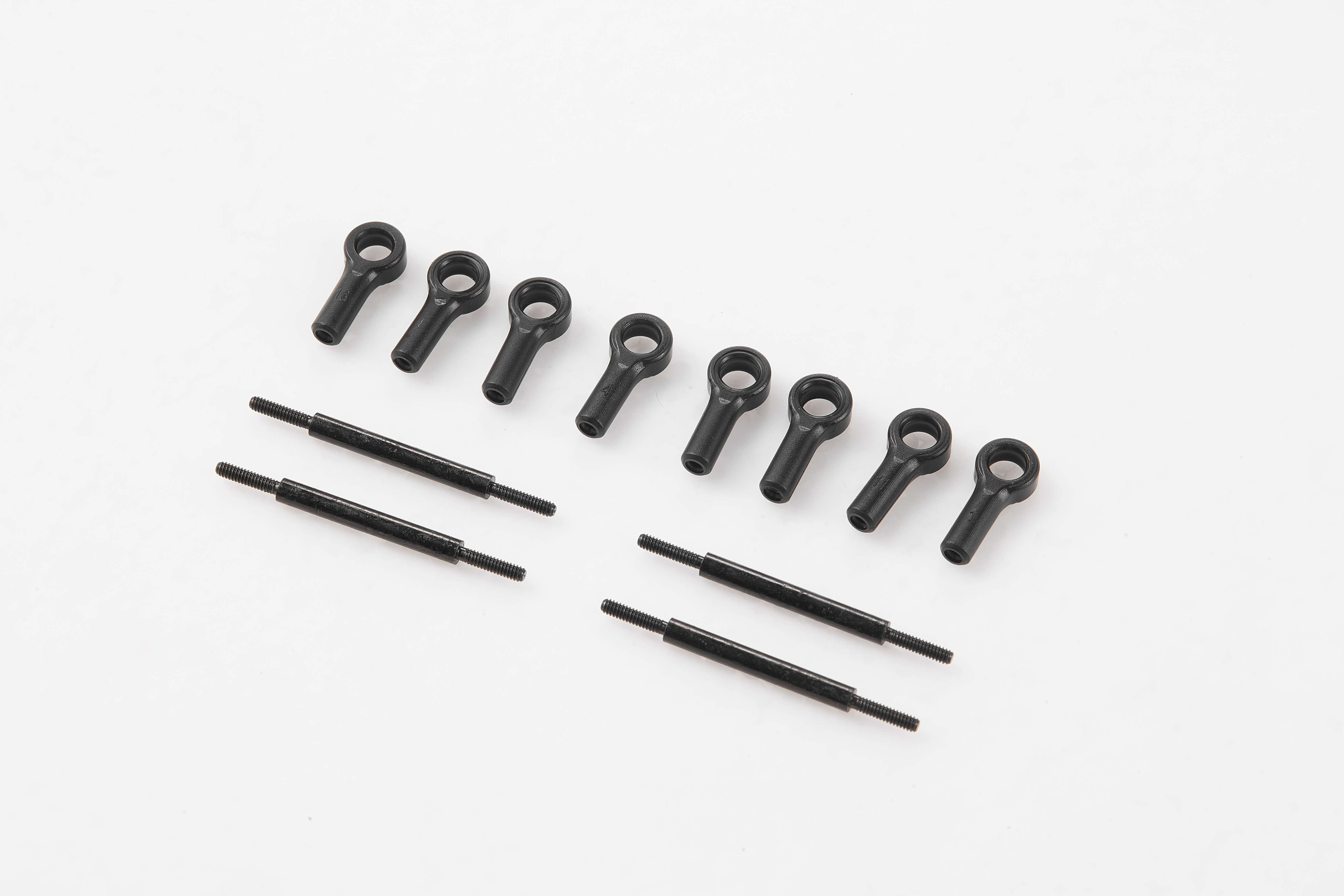 Black linkage parts for RC models, including eyelets and connecting rods.