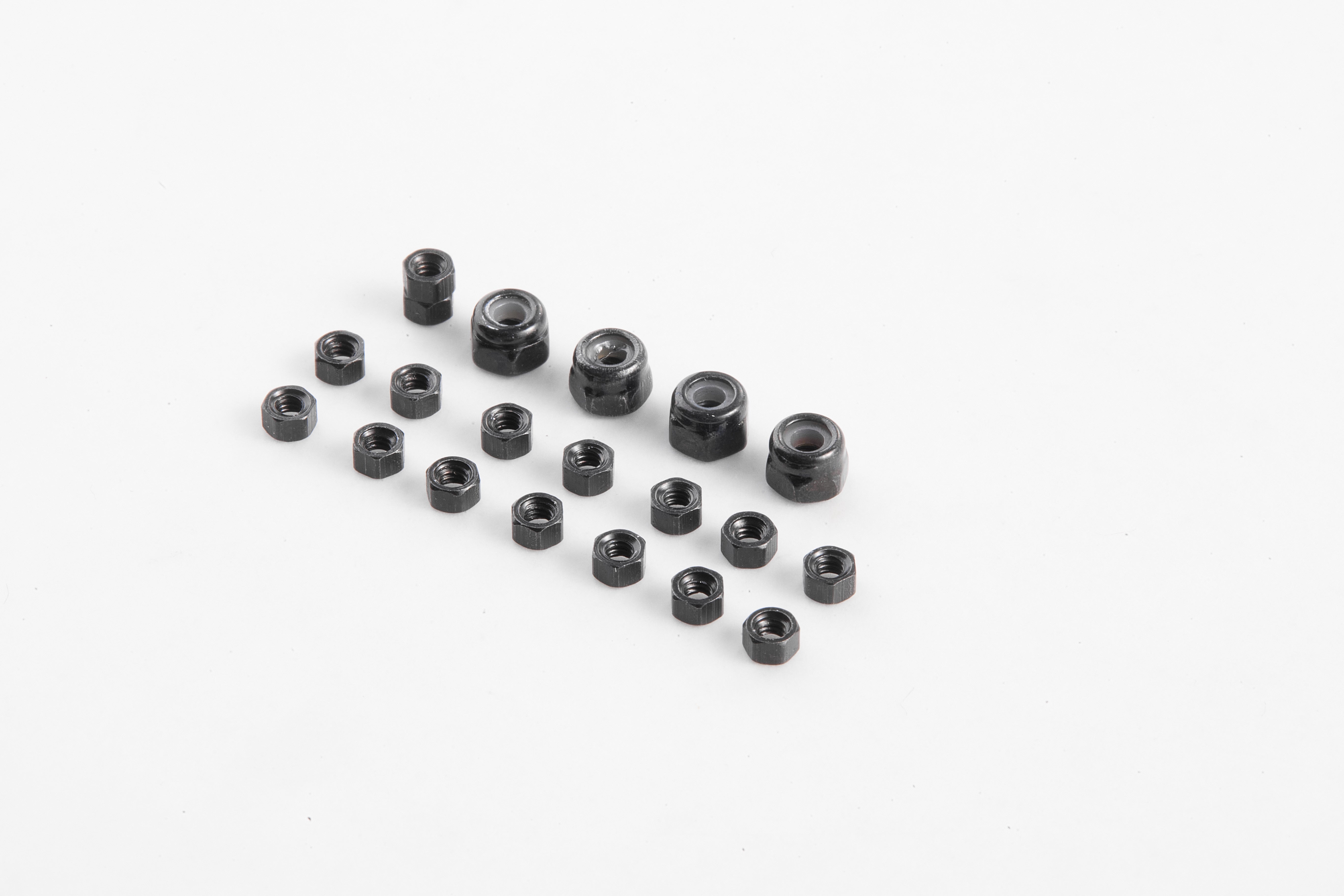 Assorted black screw nuts for RC models on a white background