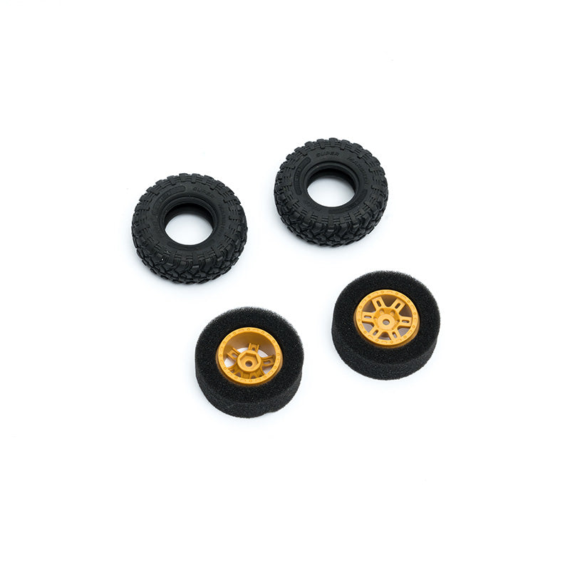 Set of four RC truck wheels with black rubber and gold rims for improved traction