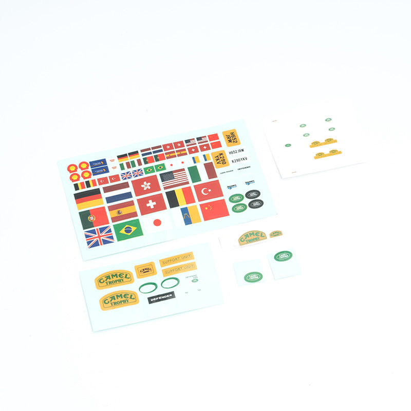 FCX24M Defender 110 car body decal sheet featuring various flags and logos.