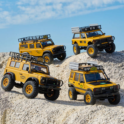 Yellow Land Rover Camel Trophy Edition RC models on rugged terrain