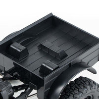 Close-up of the FMS 1:24 FCX24 Power Wagon's black, textured cargo bed interior with raised tie-down points.