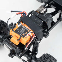 FMS 1:24 Power Wagon brushless motor and ESC unit, showing internal electronics and drivetrain components.