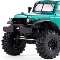 Metallic green FMS 1:24 FCX24 Power Wagon RC crawler with aggressive mud tires and black grille.