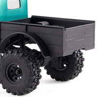 FMS 1:24 FCX24 Power Wagon Brushless RTR RC truck rear with black cargo bed and Batrazzi mud tires.
