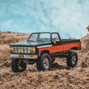 FMS 1:18 FCX18 Chevrolet K10 RTR black and orange RC truck model outdoors