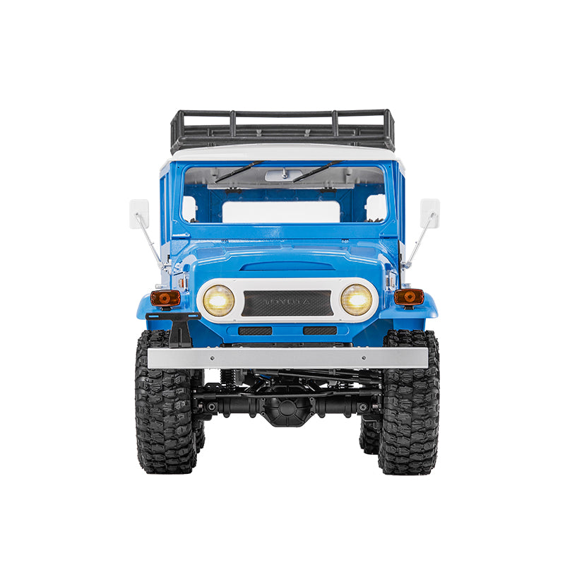 Blue FMS 1:10 Toyota Land Cruiser FJ40 RS RC rock crawler with roof rack, detailed exterior, and large off-road tires.