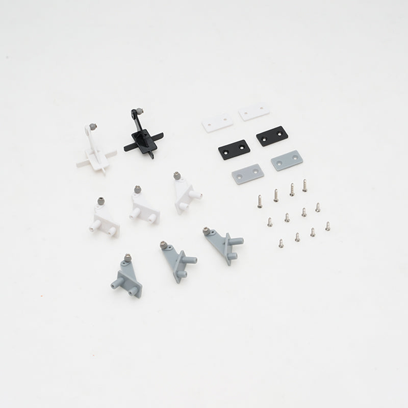 Assorted control horns and screws for RC models in black, white, and gray.