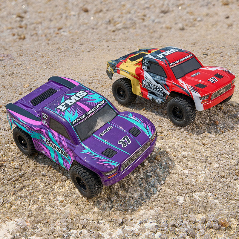 Purple and red FMS 1:24 FSC24 Chaser short course trucks with "CHASER" graphics, ready for off-road fun.