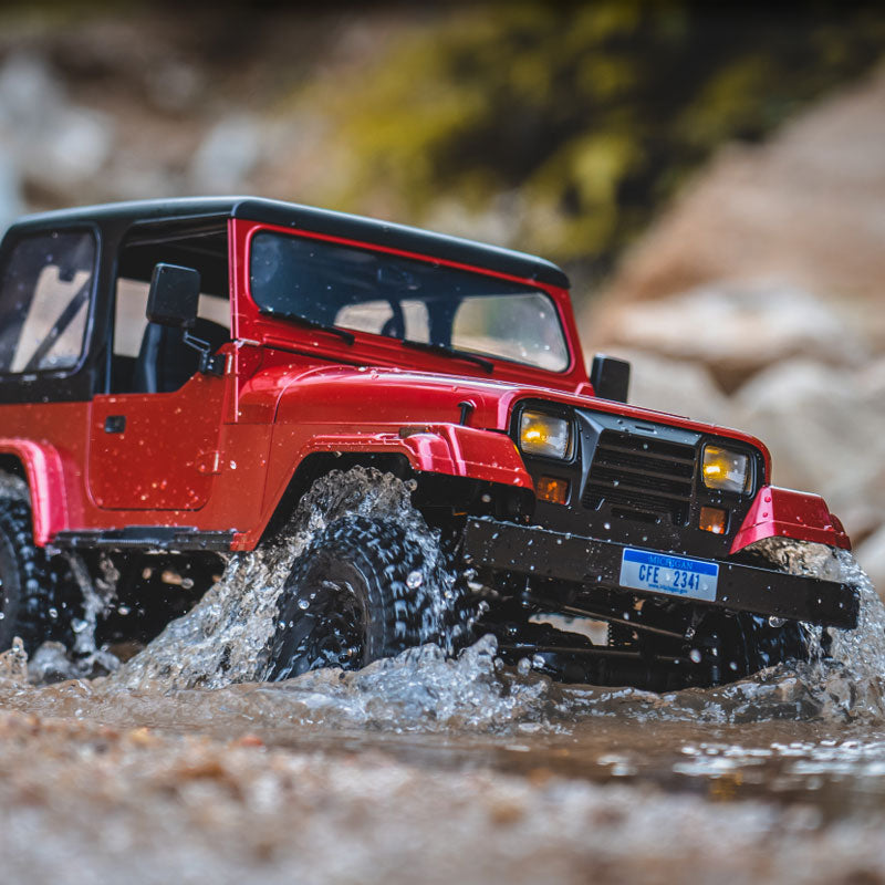 Red ROCHOBBY 1:10 Mashigan RC Rock Crawler RS splashing through water on a rocky trail, with license plate CFE 2341 visible.