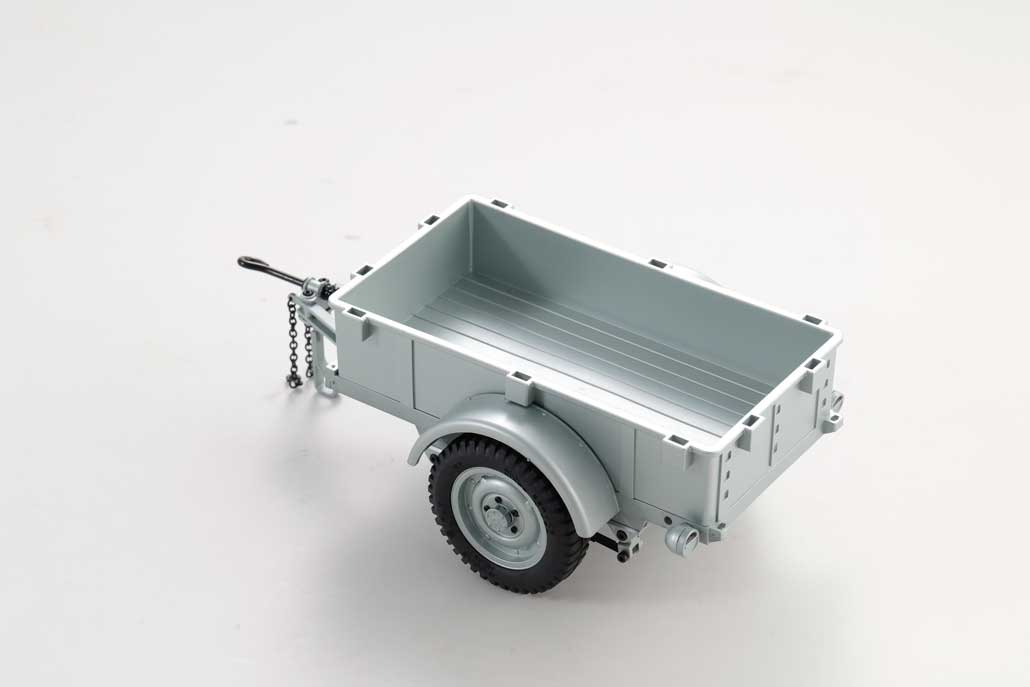Silver utility trailer for RC models with single axle and attached chain.