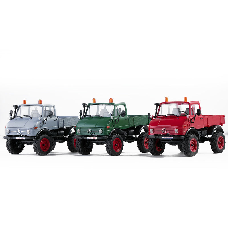 Three 1:24 scale Mercedes-Benz Unimog 421 RC trucks in blue, green, and red.