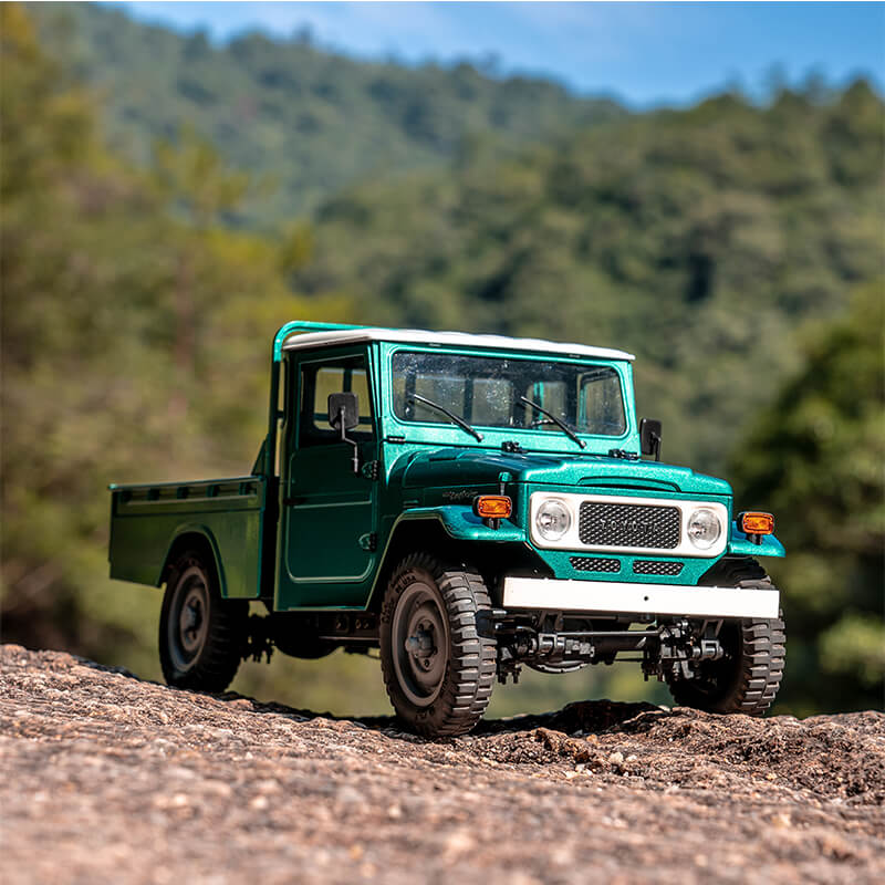 1:12 turquoise TOYOTA FJ45 pickup truck model on rocky surface