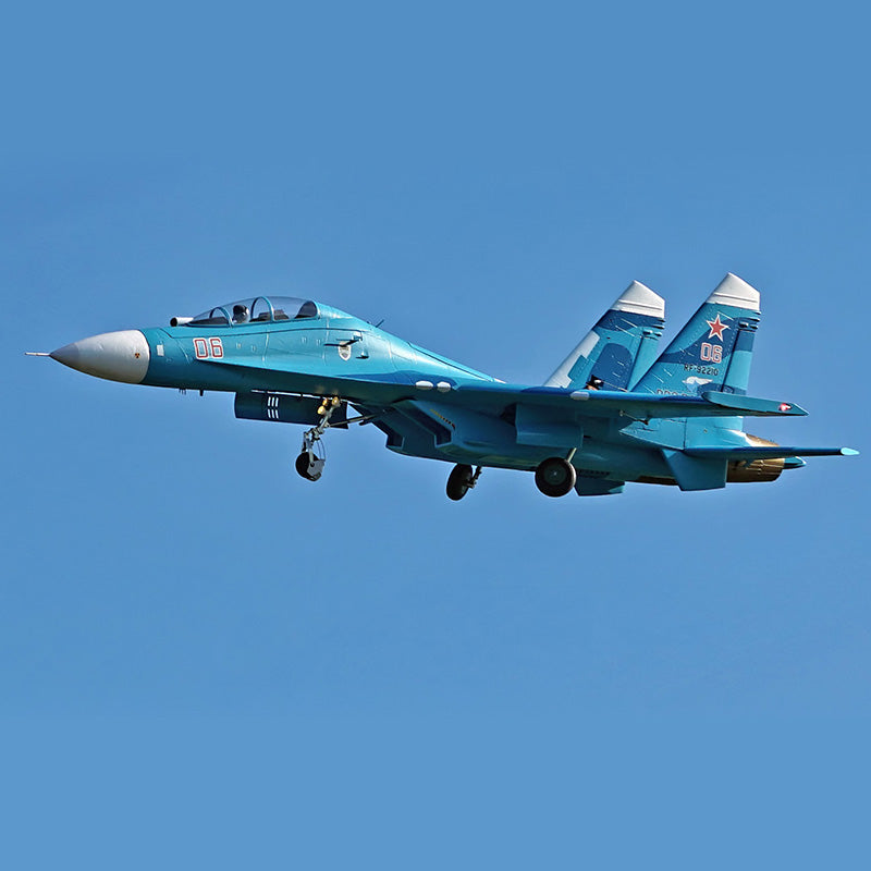 FMS Dual 70mm EDF SU-27 PNP RC jet in blue, with '06' markings, flying in clear blue sky.