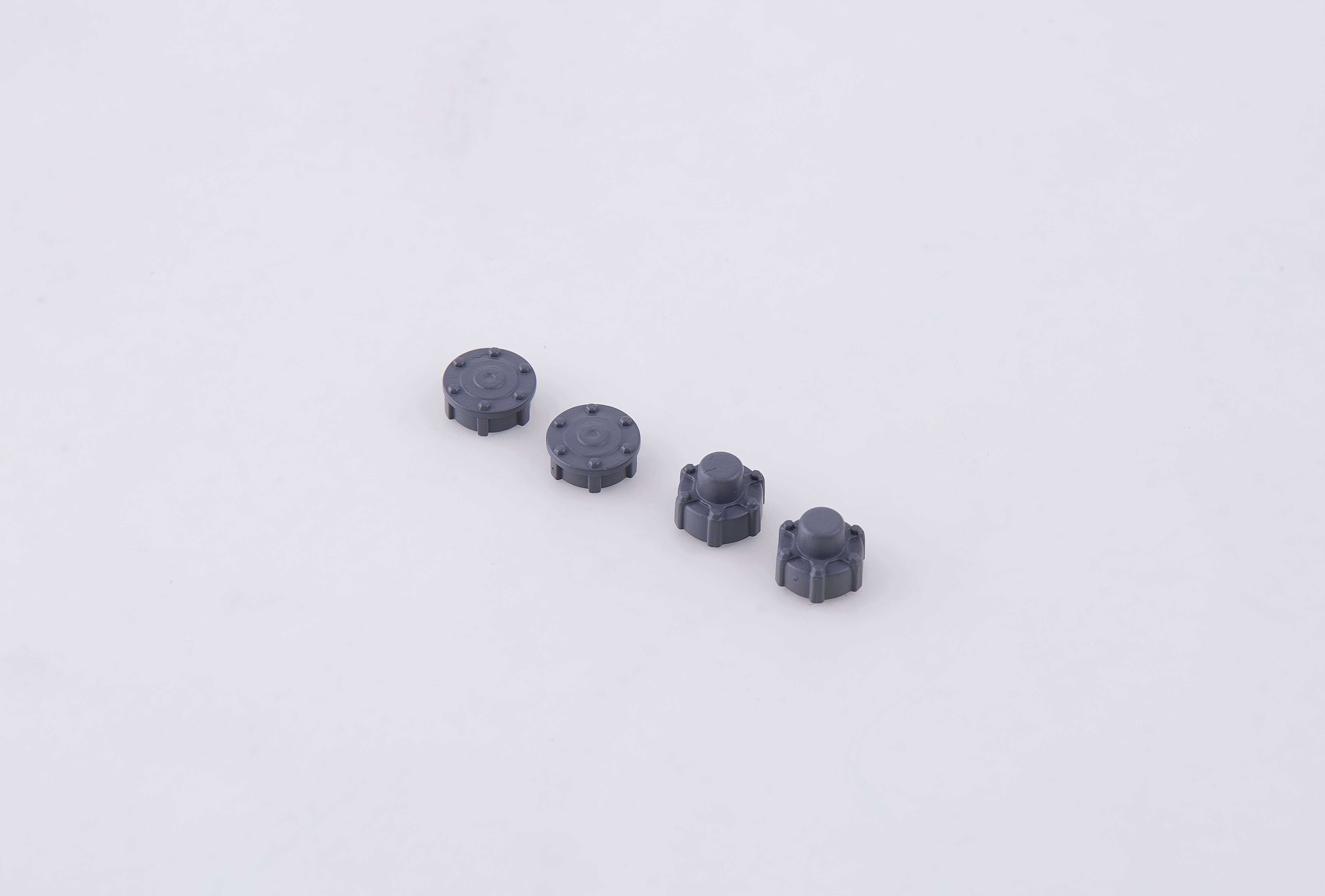 Gray plastic wheel cover parts for RC models.