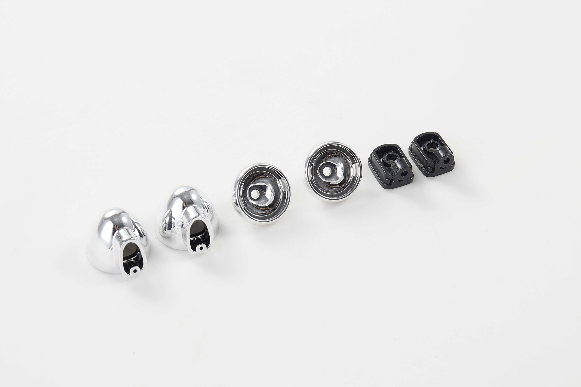 Chrome and black RC car body parts including mounting brackets