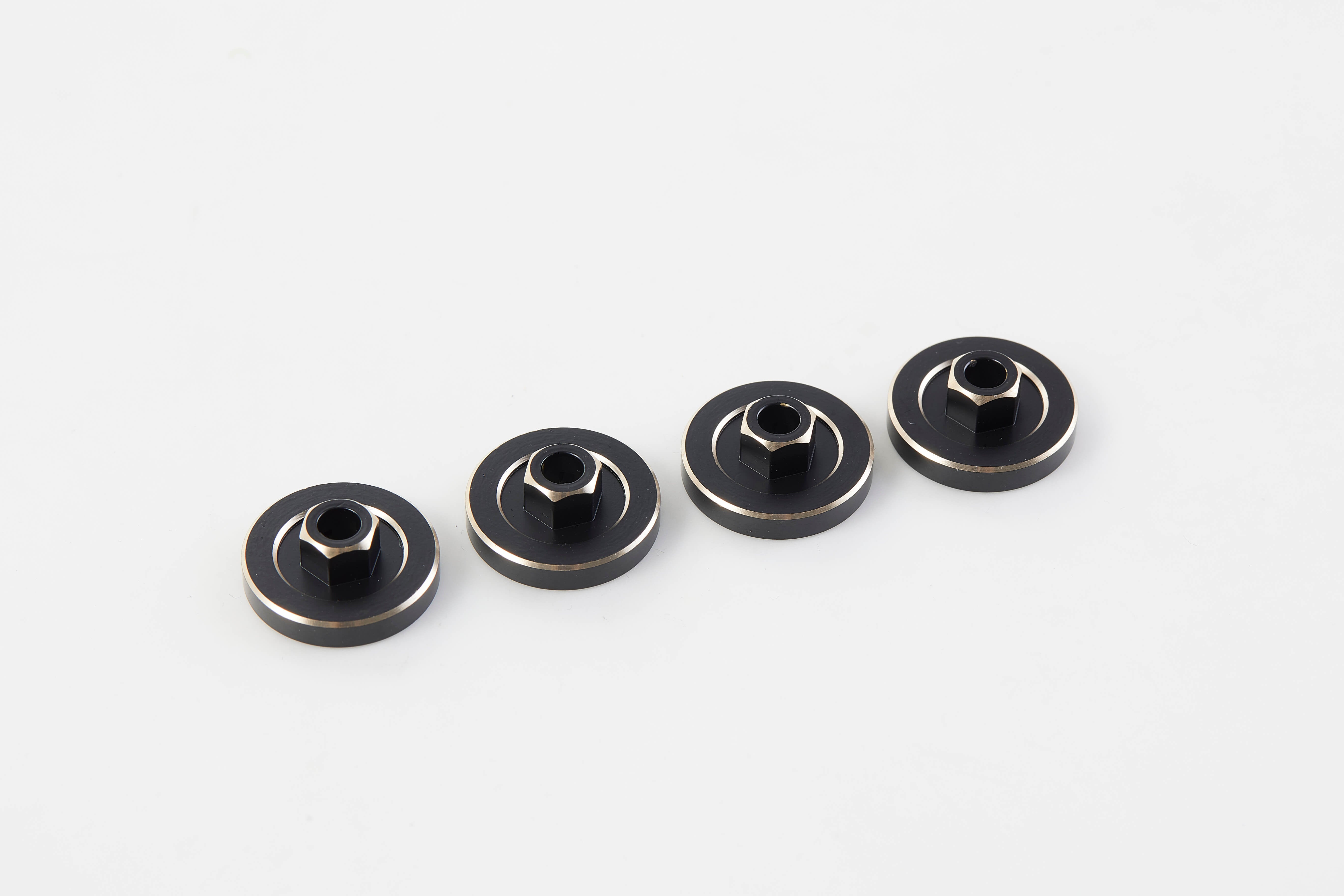 Set of four black brass wheels with silver accents for RC models