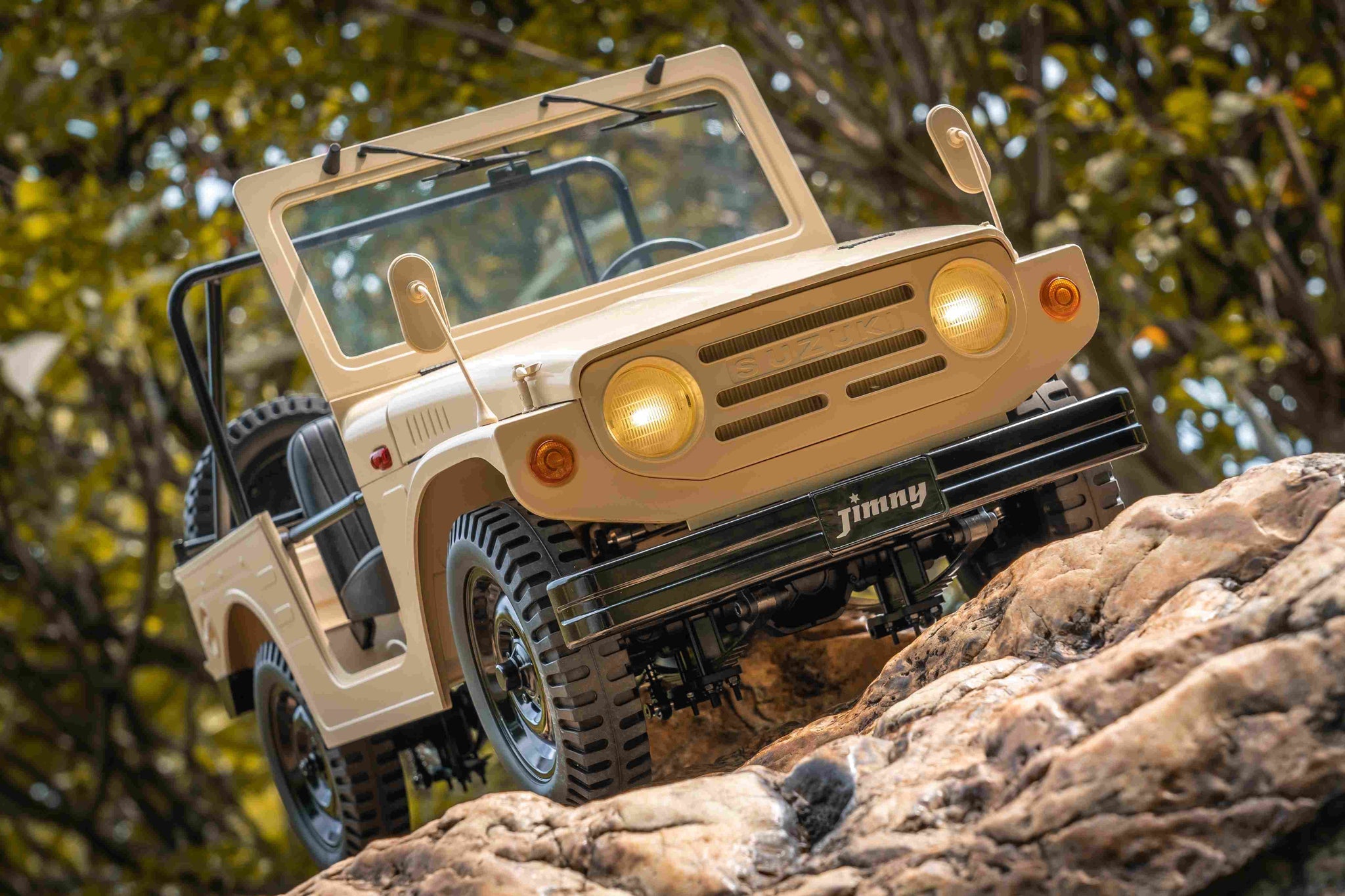 FMS 1:6 scale RC Jimny RS Brown climbing rocky terrain with detailed exterior and off-road tires.