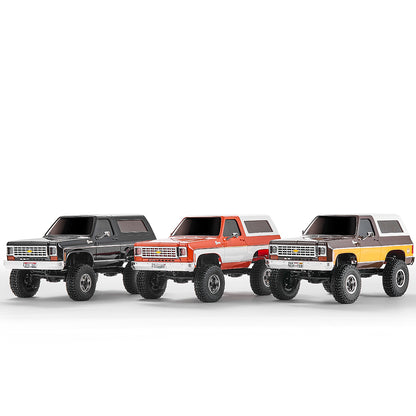 Three FMS 1:24 Chevy K5 Blazer RTR RC trucks in black, red, and yellow colors.