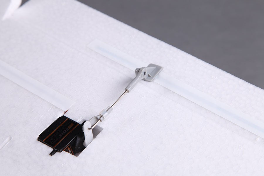 FMS 2300mm FOX V2 Glider servo linkage with FMS branding on white EPO foam.