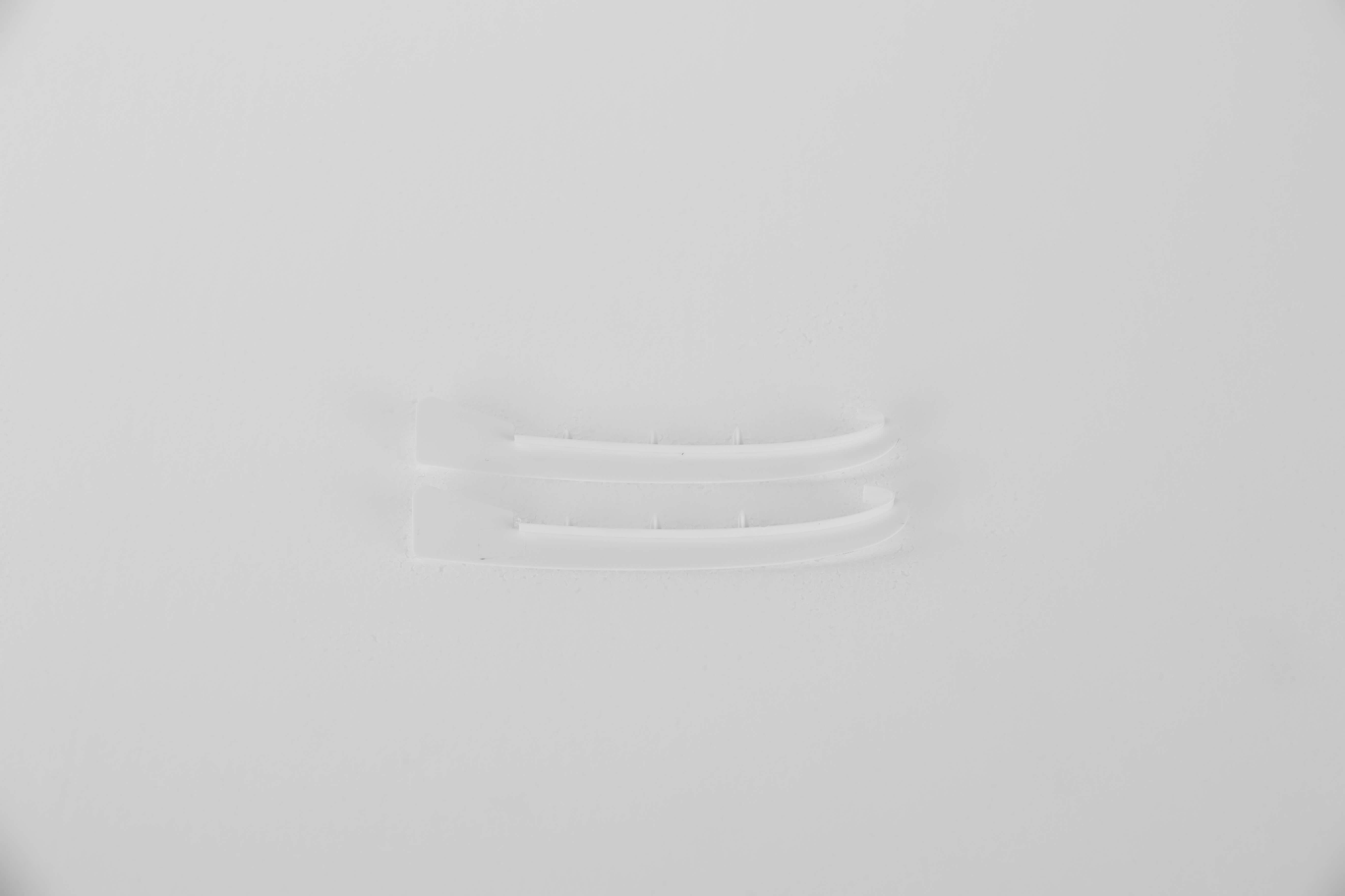 Clear plastic connectors for RC model assembly on a white background
