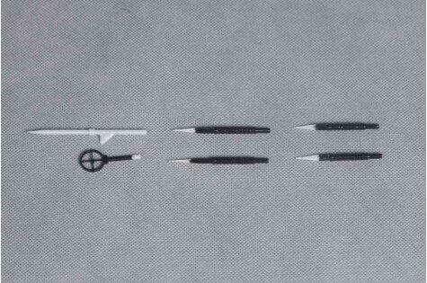 Drafting tools including pencils and a compass on gray background