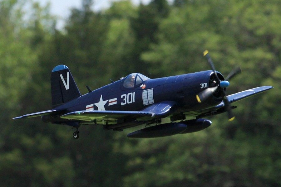 FMS 1400mm blue F4U Corsair RC plane in flight, featuring scale details like retracting landing gear and pilot figure.
