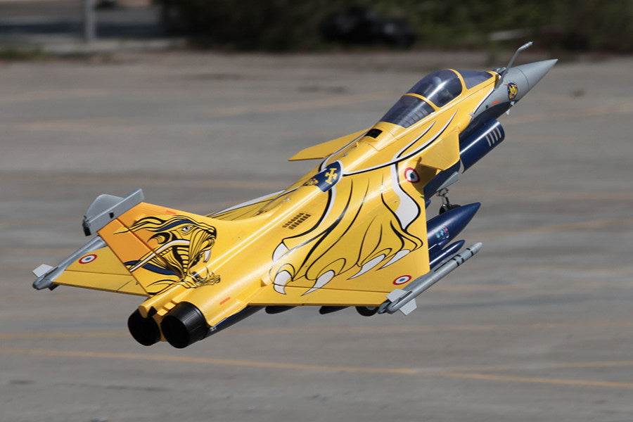 FMS 80mm Rafale EDF jet in striking yellow with black and white cobra graphics, in flight.