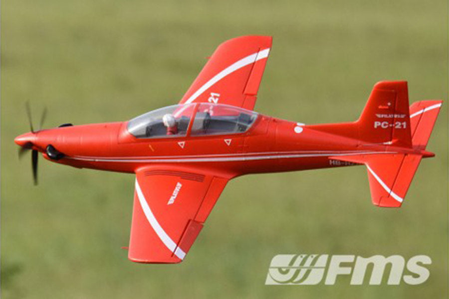 FMS 1100mm PC-21 Pilatus PNP RC airplane in flight, red with white stripes.